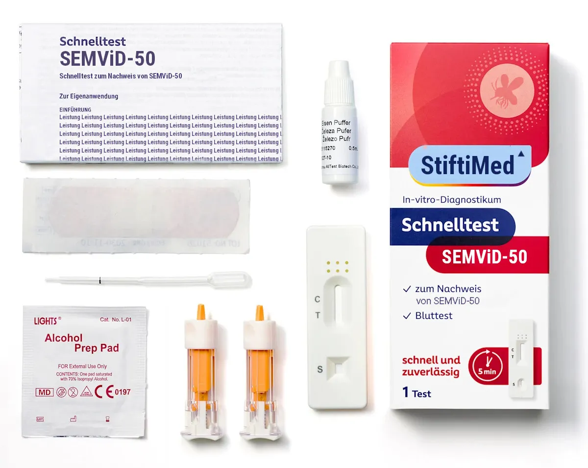 The contents of a SEMViD-50 rapid test laid out on a white surface: a German instruction leaflet headed “Schnelltest SEMViD-50”, a plaster, a pipette, an alcohol prep pad, two lancets, a buffer bottle, a test cassette marked C, T and S, and the StiftiMed box, which reads “In-vitro-Diagnostikum”, “Schnelltest SEMViD-50”, “zum Nachweis von SEMViD-50”, “Bluttest”, “schnell und zuverlässig”, “5 min” and “1 Test”.
